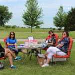 women around table at golf outing