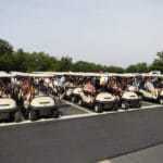 many golf carts lined up at golf outing