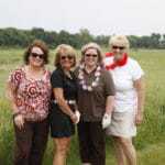 ladies next to grasslands at golf outing